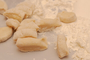Sliced raw dough into pieces prepared for cooking homemade dumplings