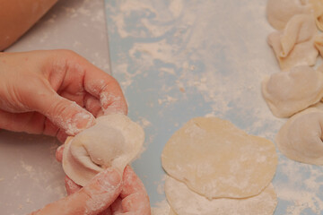 Modeling and cooking homemade dumplings woman chef at home