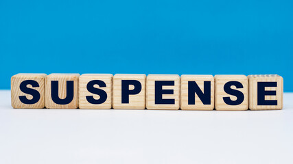 concept word SUSPENSE on cubes on a blue background
