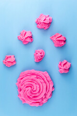 Pink marshmallows on a blue background
