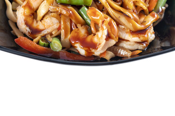 Wok with shrimp in a beautiful black plate.