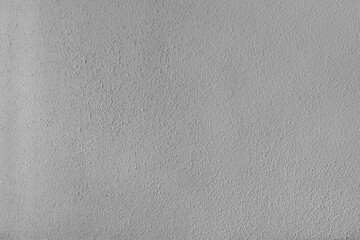 Fototapeta na wymiar White textured wall: Wall of a house lit by natural light
