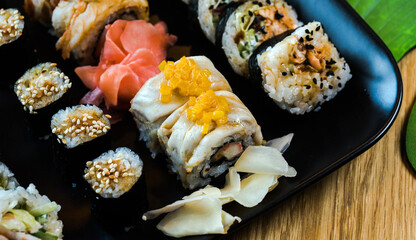 Sushi and roll set on wooden table. Selective focus