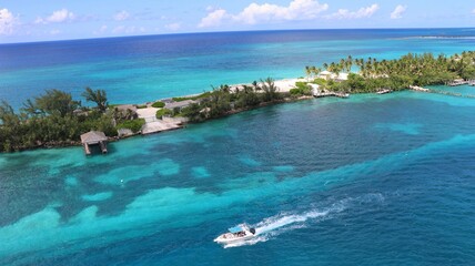 Perfect blue water, with a boat sail trough in Bahamas