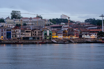 Douro river embankment at night, Ribeira district, Porto city on sunset, Portugal