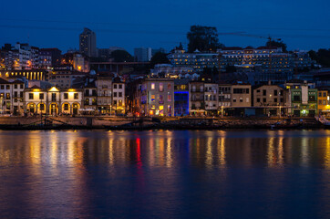 Naklejka premium Douro river embankment at night, Ribeira district, Porto city on sunset, Portugal