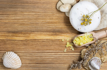 natural soap, sea salt, towel on a wooden background for Spa, bath accessories.