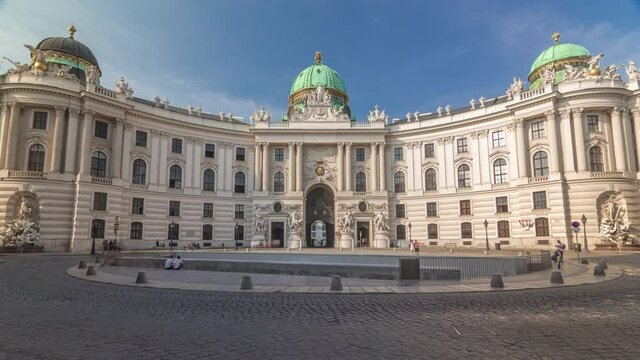 Hofburg palace timelapse hyperlapse in Vienna, Austria. People walking on Michaelerplatz. The Hofburg is the imperial palace of the Habsburg rulers in Vienna, consisting of over 2500 rooms.