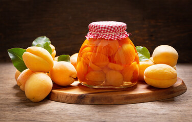 jar of canned apricots and fresh fruits