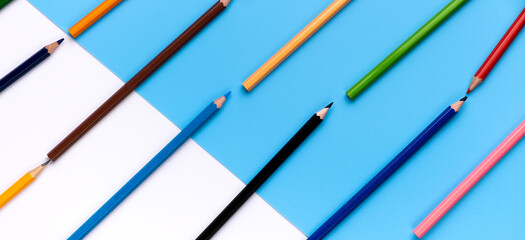 Many colorful drawing pencils on copy space background.