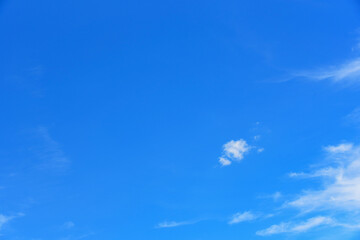 Small, fluffy and lonely clouds in the blue sky.