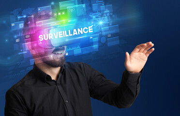 Businessman looking through Virtual Reality glasses with SURVEILLANCE inscription, innovative security concept