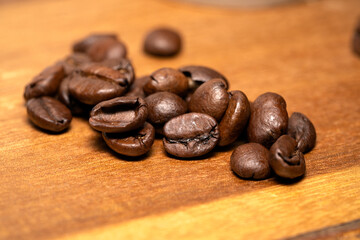 Close up on coffee beans on a wooden background