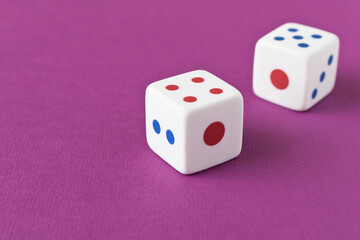 Dice on a purple background. Close up. The concept of luck in gambling.