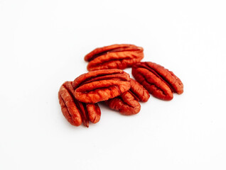 A group of raw pecan nuts, isolated on white background.