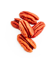 A group of raw pecan nuts, isolated on white background.