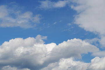 Naklejka na ściany i meble Layered summer clouds against a bright blue sky