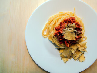 Pasta with cheese and cheese on a wooden background