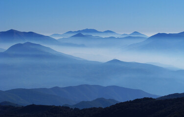 Dawn of the mountain with the sea of clouds, blue fog nature sky mountain mist. Landscape blue mountains