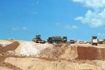 KUALA LUMPUR, MALAYSIA -JULY 17, 2019: Heavy machinery doing the soil backfilling work at the construction site. Works carried out before building construction starts to get the required levels. 
