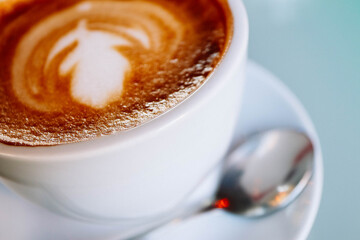 Abstract coffee background, saucer, spoon, white cup, close up.