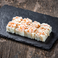Japanese cuisine. Seafood, vegetables and meat. Sushi and rolls big set isolation on a wooden table background