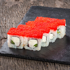 Japanese cuisine. Seafood, vegetables and meat. Sushi and rolls big set isolation on a wooden table background