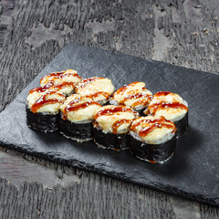 Japanese cuisine. Seafood, vegetables and meat. Sushi and rolls big set isolation on a wooden table background