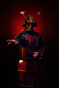 Portrait of a samurai in red armor draws his saber