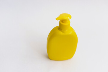 Shower gel, liquid soap plastic bottle of yellow color with a place for the text.