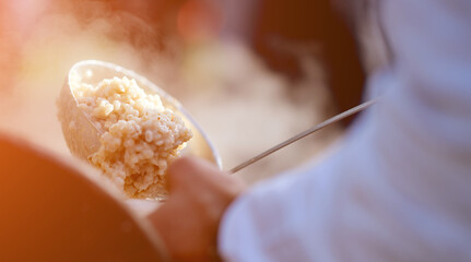 pearl porridge in the ladle is superimposed on a plate of field kitchen