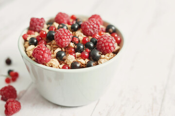 Colorful fresh berries on white background. Oatmeal with berries currants, raspberries, gooseberries. Vitamins, Diet. Copy space. Healthly food, detox. Cozy good morning! Summer Healthy breakfast