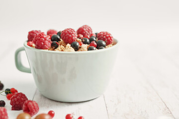 Colorful fresh berries on white background. Oatmeal with berries currants, raspberries, gooseberries. Vitamins, Diet. Copy space. Healthly food, detox. Cozy good morning! Summer Healthy breakfast