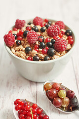 Colorful fresh berries on white background. Oatmeal with berries currants, raspberries, gooseberries. Vitamins, Diet. Copy space. Healthly food, detox. Cozy good morning! Summer Healthy breakfast