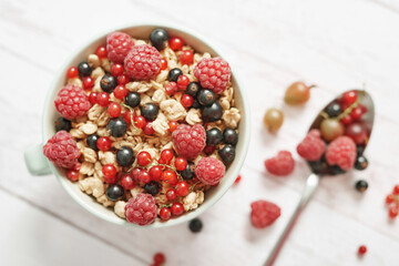 Colorful fresh berries on white background. Oatmeal with berries currants, raspberries, gooseberries. Vitamins, Diet. Copy space. Healthly food, detox. Cozy good morning! Summer Healthy breakfast
