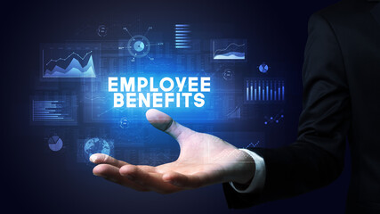 Hand of Businessman holding EMPLOYEE BENEFITS inscription, business success concept