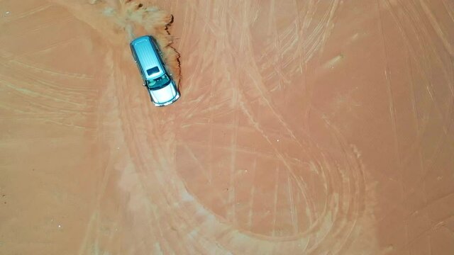 4x4 SUV dune bashing in arabian red desert 
