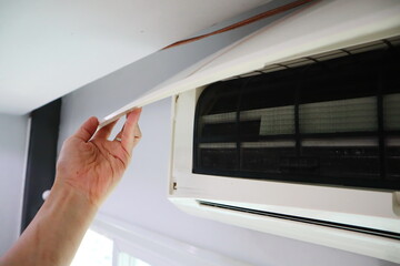 the process of clean and wash the air condition with the high pressure electric pump in the bedroom during hot summer