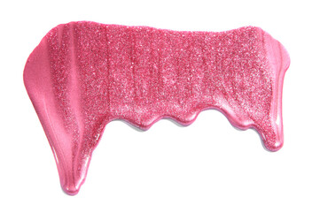 spilled pink glitter nail polish on white background