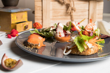 Mixed seafood appetizer, octopus, salmon, olives, prawns, passion fruit
