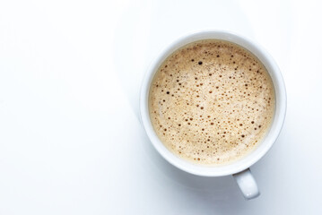 cup of foamy coffee on white