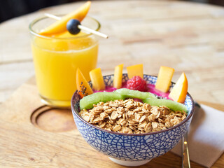oat meal bowl with fruits and orange juice