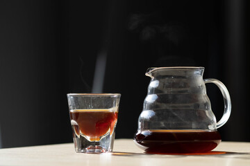 brewing coffee in a funnel. glass teapot with specialty of freshly brewed coffee. on a beautiful table, the kettle is steaming. brewing coffee. Pour Over Coffee In Funnel. Alternative Method