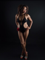 Fototapeta na wymiar Sensual and attractive African American woman wearing a one piece swimsuit