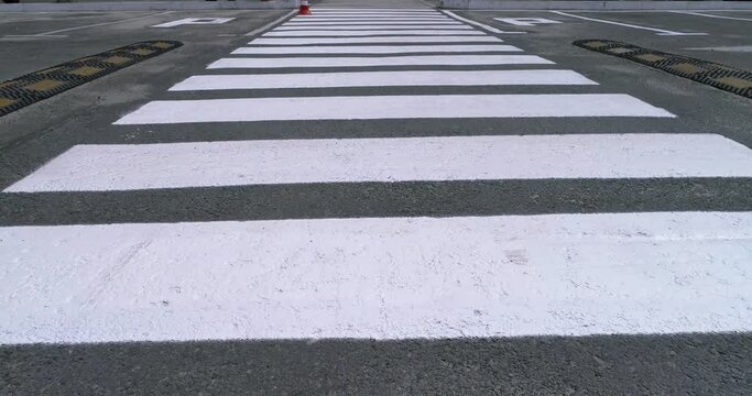 Pedestrian crossing, zebra, along the crosswalk.