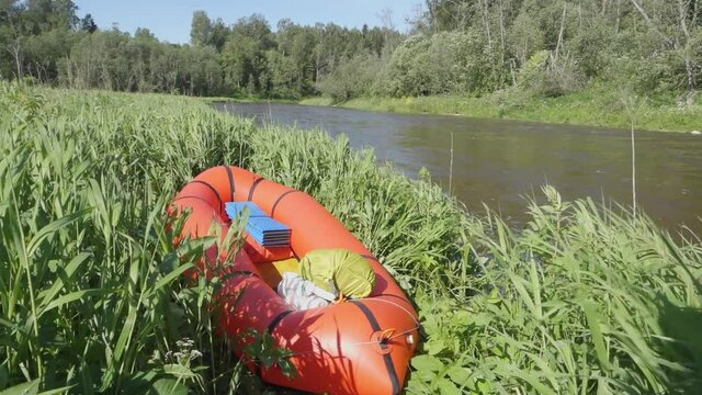 River rafting in summer. Packrafting in wilderness. Raft on the banck of river. Derzha River, Tver Region, Russia.