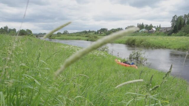 River rafting in summer. Packrafting in wilderness. Raft on the banck of river. Derzha River, Tver Region, Russia.