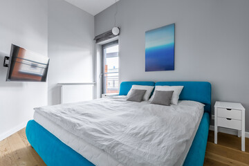 Fototapeta premium Modern bedroom with blue bed