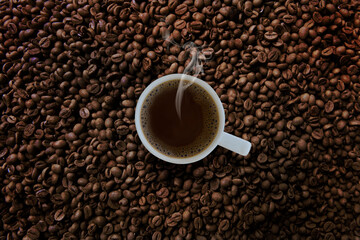 Freshness hot  coffee with coffee beans background
