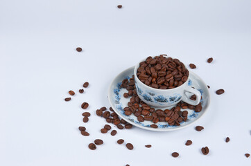 Coffee beans in a cup on a white background